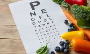 Tablica optometryczna z warzywami i owocami: marchew, brokuły, papryki, jagody, szpinak.